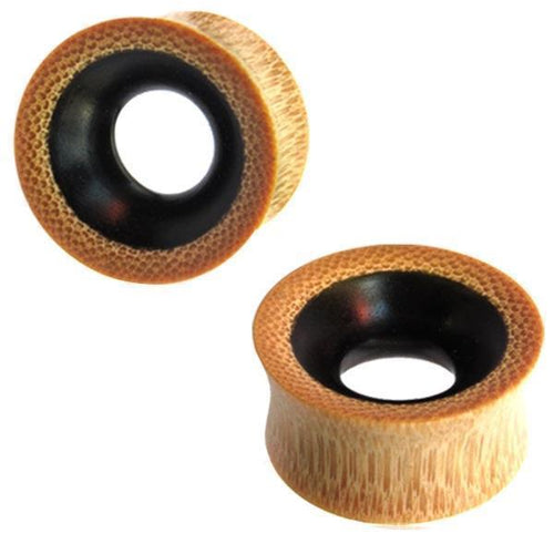 Two hand-carved Tunnel Eisenholz Bambusholz ear gauges in black and light brown with dotted grain pattern, featuring a wide tunnel shape; ideal as stylish, unisex Tribal Holztunnel plugs.