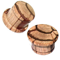 Load image into Gallery viewer, Two single-flared, light brown Tigerholz plugs with natural hand-carved patterns and tribal design are displayed against a white background.
