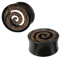 Load image into Gallery viewer, Two circular Holztunnel Spiraleninlay plugs, hand-carved from brown Eisenholz and black buffalo horn, feature a rustic spiral design inspired by Tribal Tunnel styles, blending a textured pattern with a smooth, dark background.
