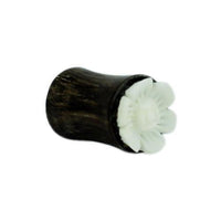 Load image into Gallery viewer, A dark brown hand-carved Tamarindenholz Holz Plug featuring a white bone Blume design, tribal style, is displayed on a plain white background.
