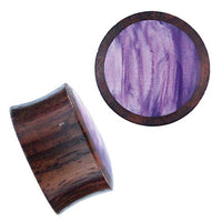 Load image into Gallery viewer, Two double flared Holz Plug Sonoholz lila schillernd Resin Inlay plugs are shown: one displays the shiny, swirled purple resin top, and the other reveals the side profile and angled view of this wooden tribal-style accessory.
