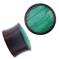 Load image into Gallery viewer, A pair of Holz Plug Sonoholz grün schillernd Resin Inlay double flared plugs, with dark brown wood sides and shimmering green resin inlay. One plug is viewed from the side, the other displays its marbled green face.
