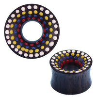 Load image into Gallery viewer, The Holz Tunnel Sonoholz handbemalt bunt Punkte Plug Polka Dots is a circular, double-flared tunnel with a flared edge, featuring vibrant hand-painted concentric rings of white, yellow, blue, and red polka dots for a bold look.
