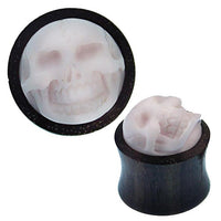 Load image into Gallery viewer, A pair of round, dark Holz Plug Sonoholz Bone Inlay Totenschädel double flared earrings with white 3D skulls on the front, shown from top and side views. Perfect organic Ohrschmuck for fans of alternative style.
