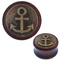 Load image into Gallery viewer, The Holz Plug Anker oxidiert features an antique golden brass inlay with a tribal tunnel expander design. Its round shape displays a raised anchor emblem and circular border, shown in close-up and full views.
