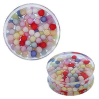 Load image into Gallery viewer, A round, transparent Acryl Plug Tunnel Expander Piercing Ohrschmuck, filled with bunte Kügelchen in pastel tones. Side view highlights the clear container and the layered arrangement of beads inside.

