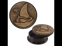 Load image into Gallery viewer, A round, antique gold brass inlay tunnel with a Segelboot and Möwe (seagull) motif. Shown closed and open, revealing a dark interior—ideal for storing small items like Ohrschmuck or a Schraub Acryl Plug.
