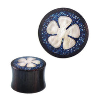 Load image into Gallery viewer, A Plug Sonoholz Resin Glitzer Inlay blau Perlmutt Blume Tunnel Tribal Expander, shown in round black design with blue glittery inlay and a white Perlmutt Blume design in the center, displayed from top and side views.
