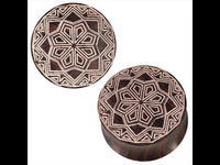 Load image into Gallery viewer, Two Brauner Holz Plugs with white tribal star Zacken gravur, featuring intricate geometric patterns, displayed against a white background.
