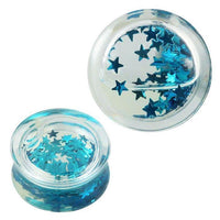 Load image into Gallery viewer, Two clear Plug Acryl transparent gauges with türkise mini Sterne glitter floating in liquid, shown from top and angled side views. These shiny Ohrschmuck plugs are perfect for stretched ear piercings.
