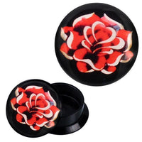 Load image into Gallery viewer, A round black Schraub Plug Acryl Lotusblume rot weiß Piercing Ohrschmuck with a vivid red and white lotus flower design. The image shows both the plug closed and opened, highlighting its screwable compartment.
