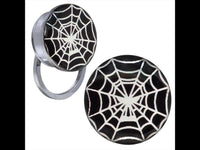 Load image into Gallery viewer, A pair of Schraub Plug Tunnel earrings made of silver stainless steel with black and white spiderweb acrylic tops, shown on a plain background.
