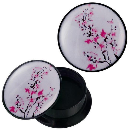 The Schraub Plug Acryl schwarz pink Blütenzweige Piercing Ohrschmuck features a round black container with a white lid decorated with pink flower branches—ideal for storing your stylish piercing jewelry.