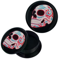 Load image into Gallery viewer, A round black Acryl Schraub Plug with a lid showcases a sweet skull design in turquoise, red, and white—bold black eye and nose sockets and a wide grin make this vibrant Ohrschmuck Piercing stand out.
