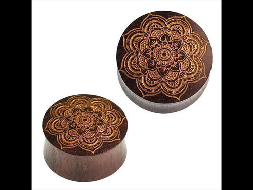 Two round, dark brown Holz Plug Mandala Blume made from Sonoholz, with golden engraved mandala designs on their flat surfaces, presented against a white background.