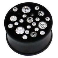 Load image into Gallery viewer, A black, hand-carved ironwood tribal plug tunnel expander featuring variously sized clear crystals on top.
