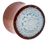 Load image into Gallery viewer, A round Sawoholz Plug in natural brown with a carved floral bone inlay pattern, featuring detailed petals and circular motifs, reminiscent of fine craftsmanship—ideal as an expander tunnel.

