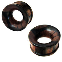 Load image into Gallery viewer, Two round, dark brown Holztunnel Tigerholz ear gauges with natural grain, domed shape, flared edges, and hand-carved tribal design, shown polished on a white background.
