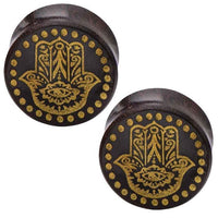 Cargar imagen en el visor de la galería, These round, dark brown Holz Plugs are crafted from Tamarind wood and feature gold-painted Khamsa (Hand of Fatima) designs with dotted borders, as described in the Holz Plug Poor Mans Hand Tamarind Khamsa Punkte gold Tunnel.
