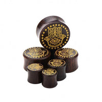Cargar imagen en el visor de la galería, Six dark Holz Plug Poor Mans Hand Tamarind Khamsa Plugs with gold painted Fatima eye design, laser engraved dots, and tribal details, arranged on a white background.

