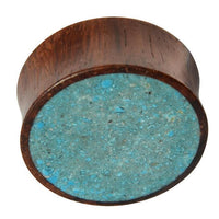 Cargar imagen en el visor de la galería, The Holz Plug Sonoholz Crushed Türkis Inlay double flared features a flat, circular face with inlaid crushed Türkis and a textured, speckled surface for a unique tribal expander look.
