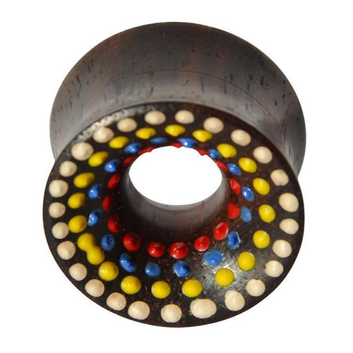 The Holz Tunnel Sonoholz handbemalt bunt Punkte Plug Polka Dots is a dark, cylindrical tunnel with double flared ends, featuring hand-painted concentric rings of red, blue, yellow, and white polka dots around a central hole.
