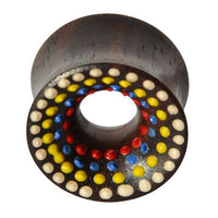 Load image into Gallery viewer, The Holz Tunnel Sonoholz handbemalt bunt Punkte Plug Polka Dots is a dark, cylindrical tunnel with double flared ends, featuring hand-painted concentric rings of red, blue, yellow, and white polka dots around a central hole.

