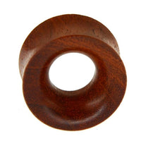 Load image into Gallery viewer, A close-up of the Blutholz Flesh Tunnel rötlich, a handmade double flared wooden ear tunnel for stretched piercings, is shown against a white background.
