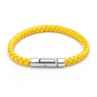 Load image into Gallery viewer, A yellow round braided Lederarmbänder aus Leder with a shiny silver Knopfverschluss (nickelfrei, unisex) is shown against a white background.
