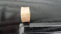Load image into Gallery viewer, A hand-carved Bananenholz Plug Naturmaserung Holzplug Tribal Tunnel Ohrstecker Expander stands upright next to a clear ruler on dark wood, showing a diameter of about 2 centimeters.
