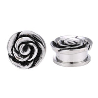 Load image into Gallery viewer, Two silver Plug Schraubplug Edelstahl ear pieces shaped like large ribbed rose blossoms, featuring detailed swirling petal designs—ideal for your lobe piercing. One stands upright, the other lies on its side.
