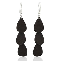 Cargar imagen en el visor de la galería, These Holzohrringe Tropfen lang (68 mm) feature three stacked, matte black, teardrop-shaped pieces on each earring, hanging from stainless steel hooks—stylish, nickel-free, and perfect for everyday wear.
