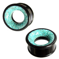 Load image into Gallery viewer, Two unisex Holz Tunnel türkis schwarz plugs made from Eisenholz, each featuring a ring of crushed turquoise stone inlay around the hollow center, displayed from multiple angles.
