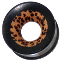 Load image into Gallery viewer, The Tunnel Punktmuster Kokosholz Eisenholz Tribal is a hand-carved brown-black Holztunnel Plug with a circular shape, hollow center, and features a striking black patterned ring.
