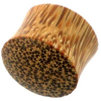 Load image into Gallery viewer, Close-up of a hell Holz Plug Punkte Muster Kokosholz handmade, featuring a textured, wood-like pattern with dark grainy spots, reminiscent of an Organic Tunnel or Kokosholz Plug.
