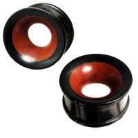 Load image into Gallery viewer, Two black and brown hand-carved Holz Tunnel Eisenholz Rotholz ear gauges are shown from different angles on a white background. These wooden tunnels have flared edges and a smooth, polished finish.

