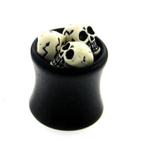 Load image into Gallery viewer, A small black cauldron filled with miniature cracked skulls, perfect for displaying your Plug Totenköpfe Tunnel Ohrstecker Ohrring Expander Dehner Piercing Ohrschmuck Unisex schwarz weiß against a white background.
