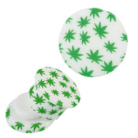 Load image into Gallery viewer, The Schraub Plug Acryl weiß und grüne Hanfblätter Piercing Ohrschmuck features a white round acrylic plug with green cannabis leaf patterns, displayed from side and top views against a plain white background.
