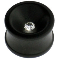 Load image into Gallery viewer, A hand-carved black Eisenholz plug with a concave shape and a clear Kristall at its center, inspired by Tribal Holzplug designs, is shown against a white background.
