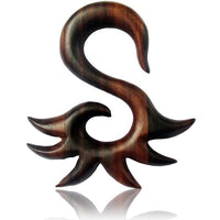 Cargar imagen en el visor de la galería, The Sonoholz Tribal Piercing Holz S-Form Spitzen Unisex Expander is a hand-carved, organic wooden decorative piece shaped like an abstract S with pointed, wave-like extensions, shown against a white background.
