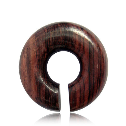 The Piercing Narraholz Holz Expander in dark brown is a large wooden ear expander with visible grain, featuring a central hole and narrow slit—ideal as an Ohrstecker, Ring, or Dehner for your lobe piercing.