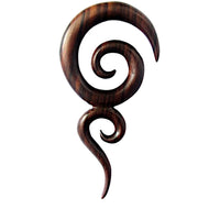 Load image into Gallery viewer, The Sonoholz lang Tribal Piercing Holz zwei Spiralen handmade is a dark wooden earring with smooth, curving spirals and pointed ends, making it a striking accessory set against a white background.
