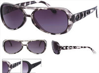 Load image into Gallery viewer, The Sonnenbrille Unisex Brille dunkel getönt 400 UV Punkte Ausstanzung features black and gray marbling, dark lenses with UV 400 protection, and arms with circular cut-out holes. Images show front, side, angled views, plus close-up details.
