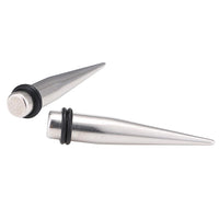 Load image into Gallery viewer, Piercing Spike Expander Edelstahl silbern Ohrstecker zwei Gummiringe schwarz
