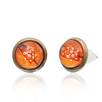 Cargar imagen en el visor de la galería, A pair of 12mm round, nickelfrei Brass Ohrstecker earrings featuring a colorful star pattern, bronze-colored rims, and orange glass centers. These unisex stainless steel earrings come with clear plastic backings.
