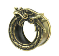 Load image into Gallery viewer, The Brass Tunnel Midgard Viking Weltenschlange antik gold features a circular, ornate dragon biting its own tail, with detailed scales and facial features, symbolizing the ouroboros, set against a white background.
