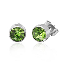 Load image into Gallery viewer, A pair of Brass Ohrstecker silber Glaskristall facettiert 6mm rund bunt hoch earrings features silver studs with round, faceted green glass crystals in bezel settings. Displayed on white, one is upright and the other angled to reveal the backing.
