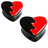 Load image into Gallery viewer, Two glossy &quot;Plug Herz gebrochen schwarz rot Holz broken Heart&quot; heart-shaped items, split diagonally into red and black jagged sections, resemble broken hearts and can serve as decorative containers or unique Sonoholz Piercing accessories.
